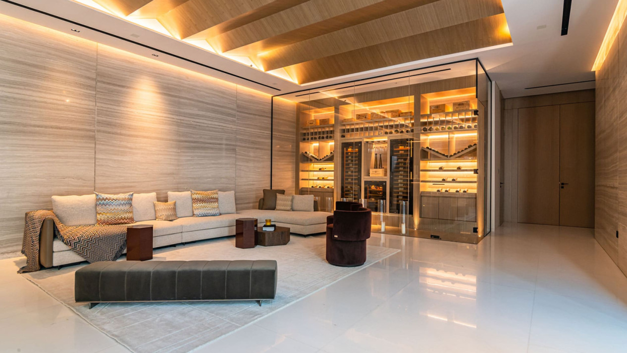 Glass-enclosed wine area with integrated wine fridges in a high-end living room