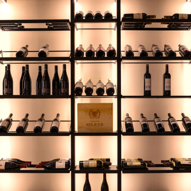 Wine room display. Modular metal structure with integrated lighting for an elegant showcase of wine bottles.