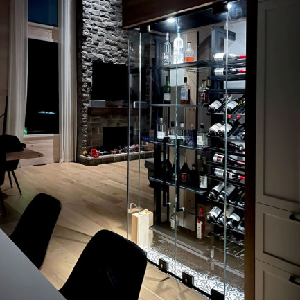 An illuminated wine display case that both delimits esapces and creates a tasting area.