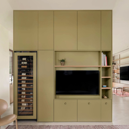 Built-in wine cooler fitted in a beautiful custom-made green piece of furniture by EuroCave.