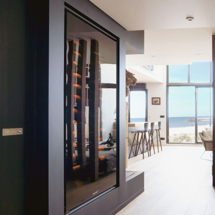 Integrated wine ageing fridge EuroCave Royale in a unique living design space with sea view.