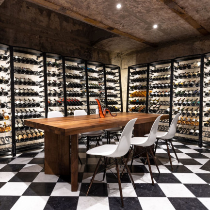 Luxurious interior design wine room fitted with EuroCave Modulosteel metal storage and checkered floor.