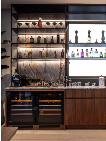 wo side-by-side under-counter wine fridges with glass doors integrated into a bar area